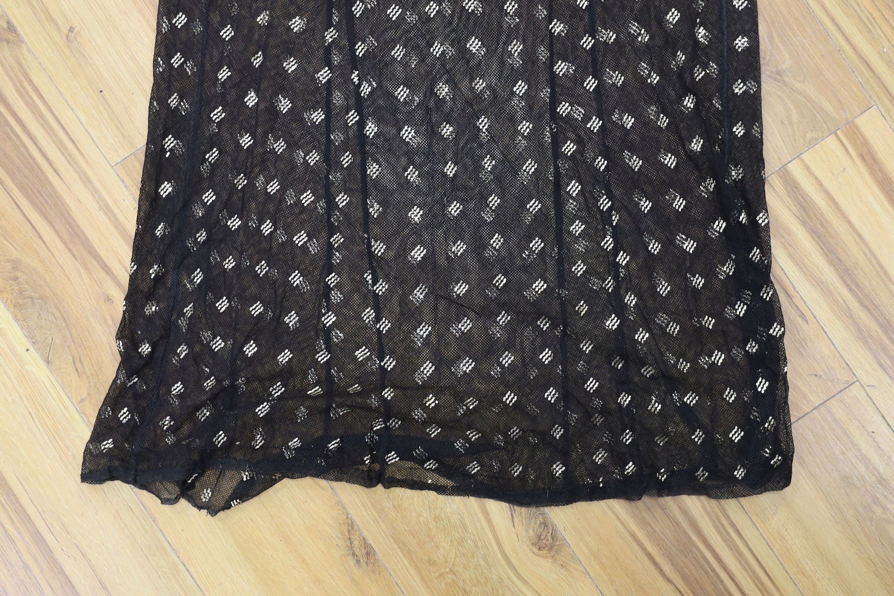 A dress made from a metal and black net Egyptian shawl; a similar shawl and a piece of shawl